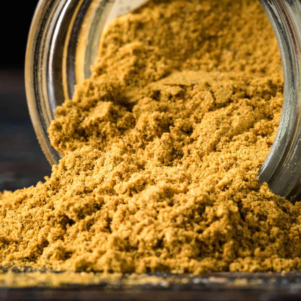 Curry powder pouring out of jar.