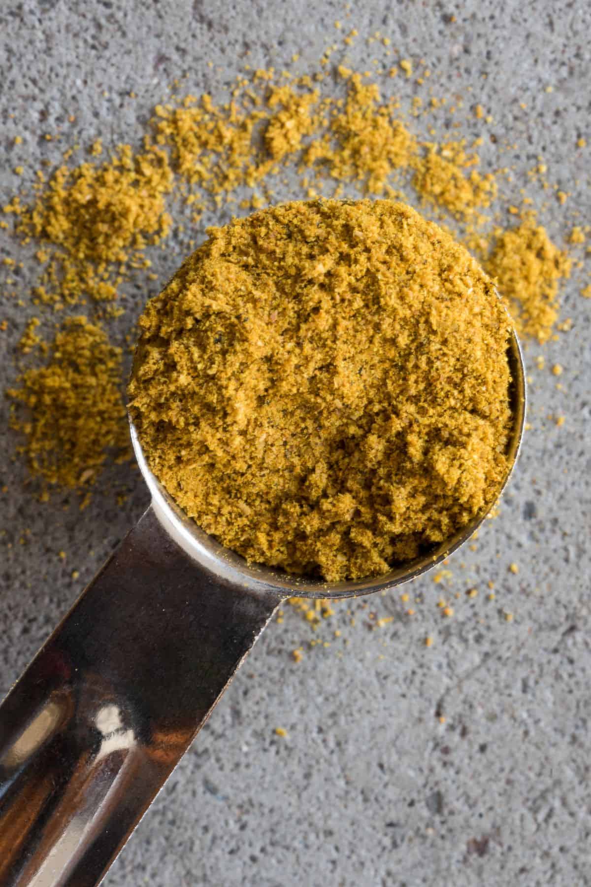 Curry powder in a measuring spoon.